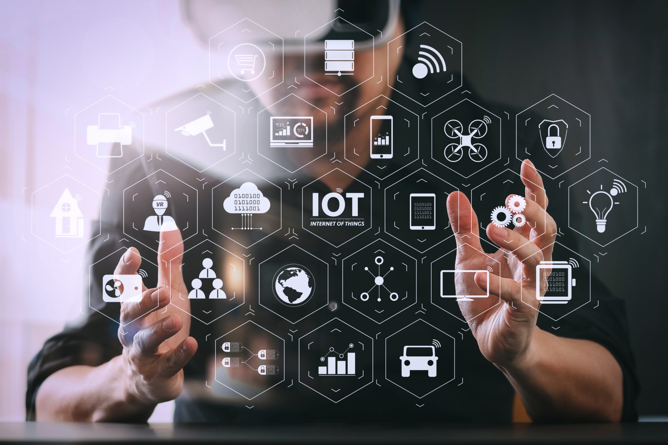 A person is holding a device related to IoT (Internet of Things). The image appears to be a screenshot taken indoors, featuring text alongside the individual. Tags associated with the image include "screenshot," "person," "text," and "indoor."